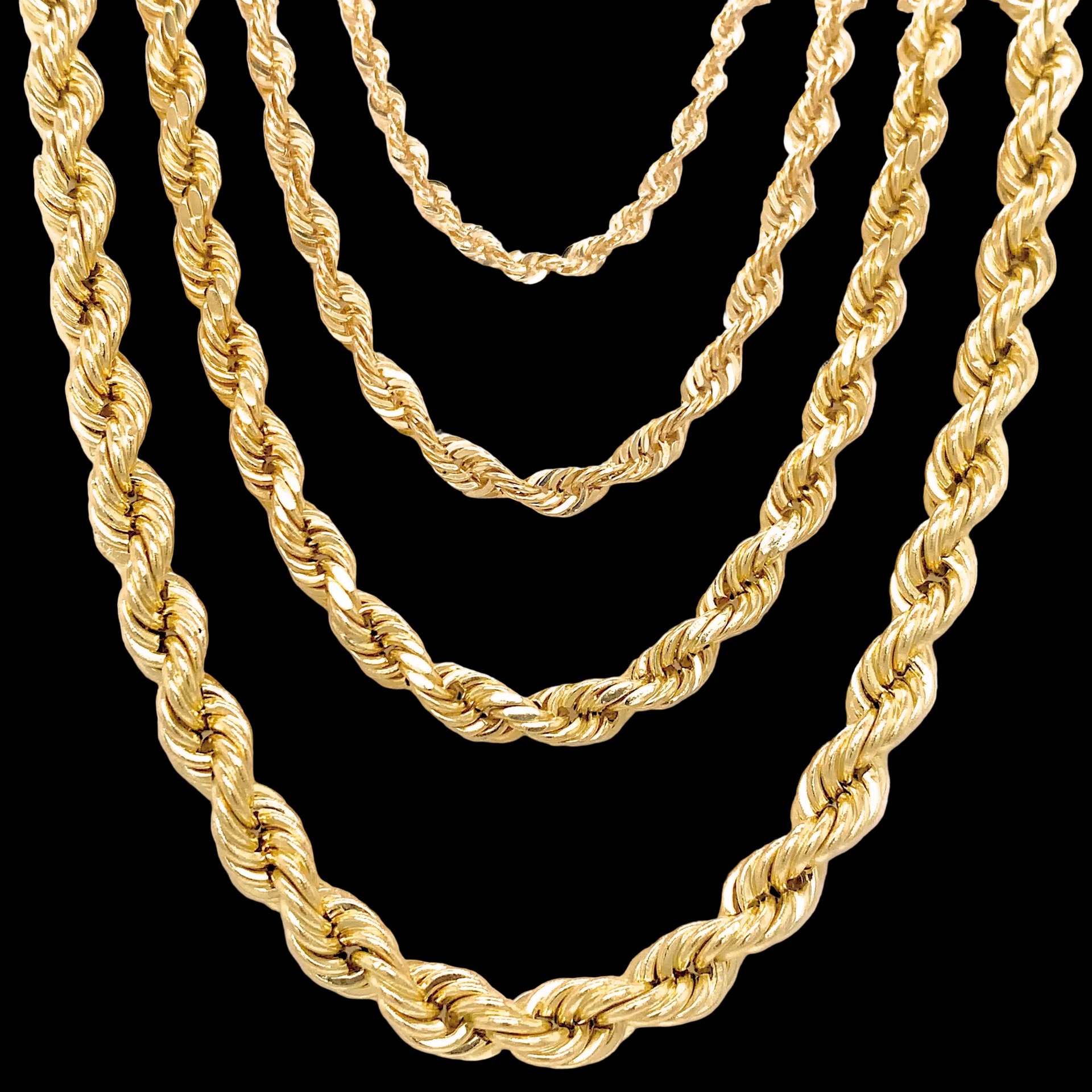 Five gold rope chains of increasing thickness arranged in concentric loops on a black background